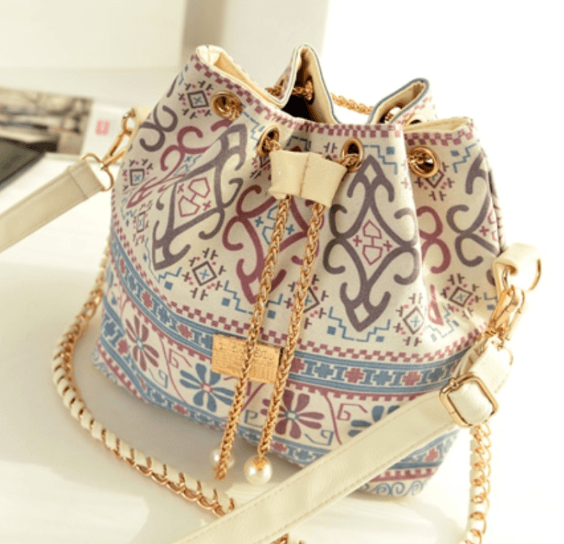 Ethnic style canvas bucket bag featuring intricate patterns and a stylish chain strap.