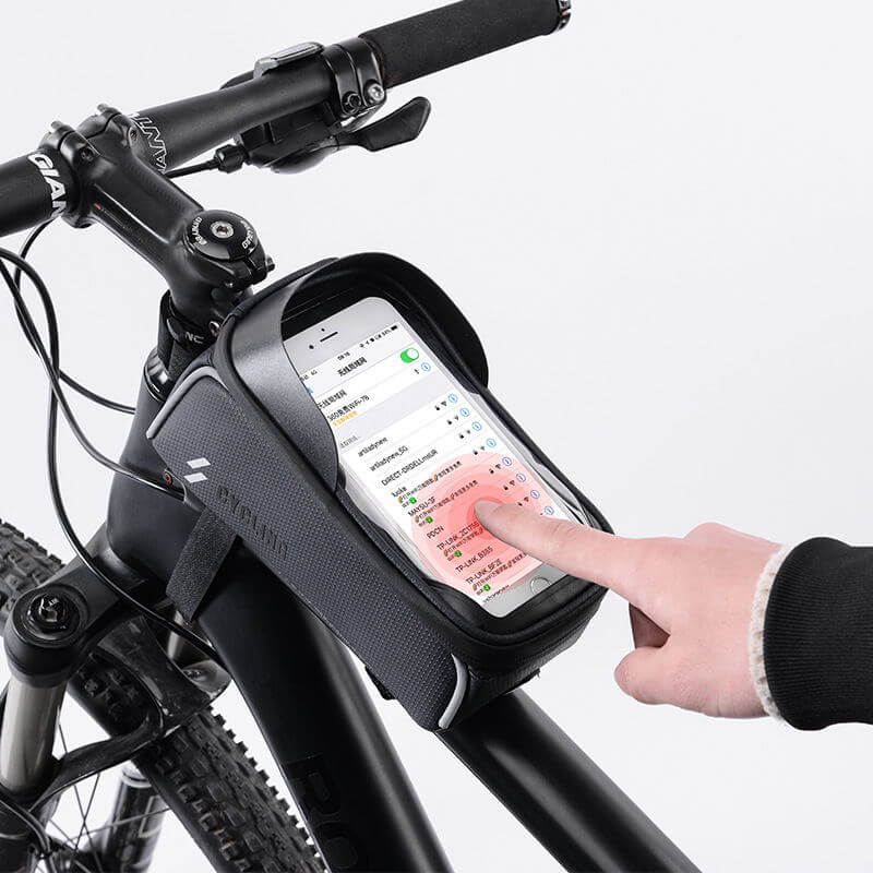 handlebar bicycle bag mounted on a bicycle with a hand interacting with a smartphone inside