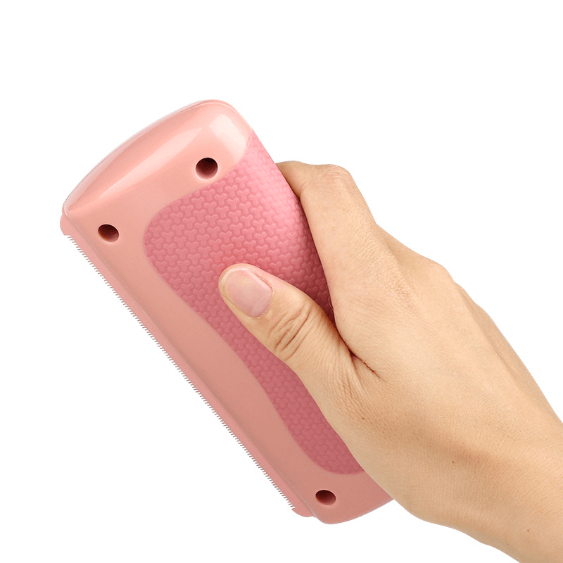 Pet grooming comb held in hand, showcasing ergonomic grip and dual serrated and smooth teeth for effective grooming.