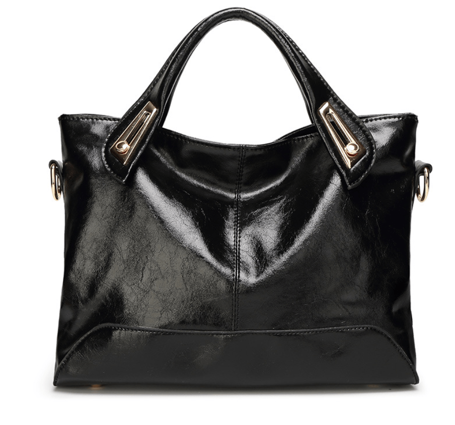 Chic crossbody bag made from high-quality black leather with sleek design and elegant handles.