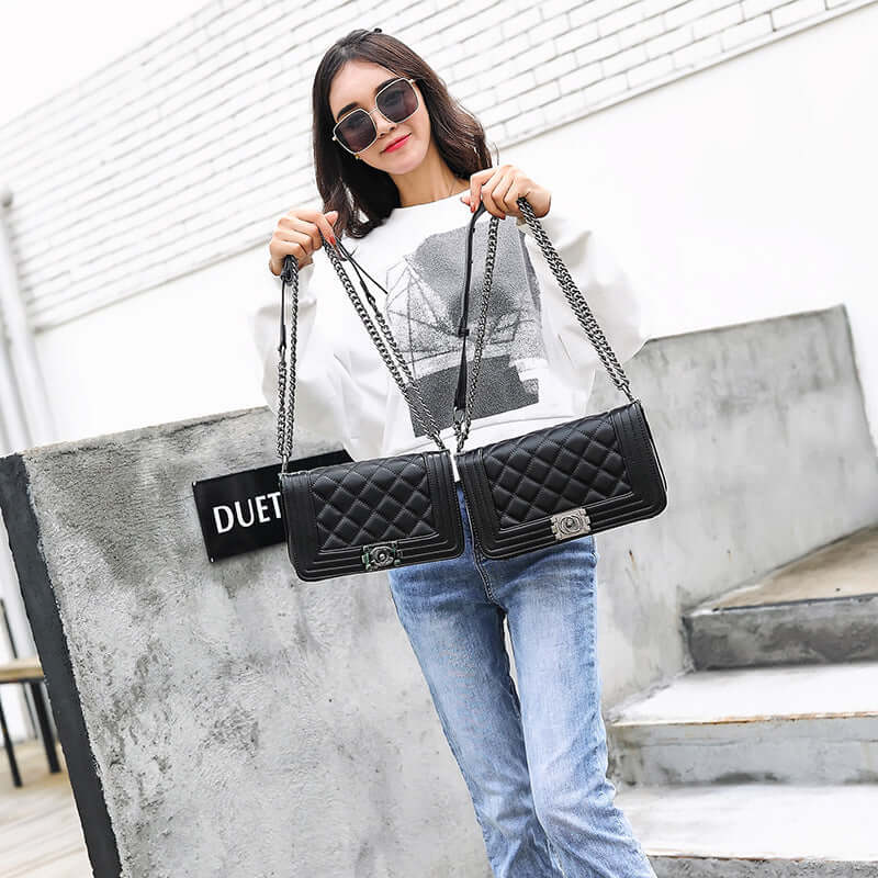 Stylish chain shoulder bag displayed by a model, featuring a quilted design and chain strap for versatile wear.