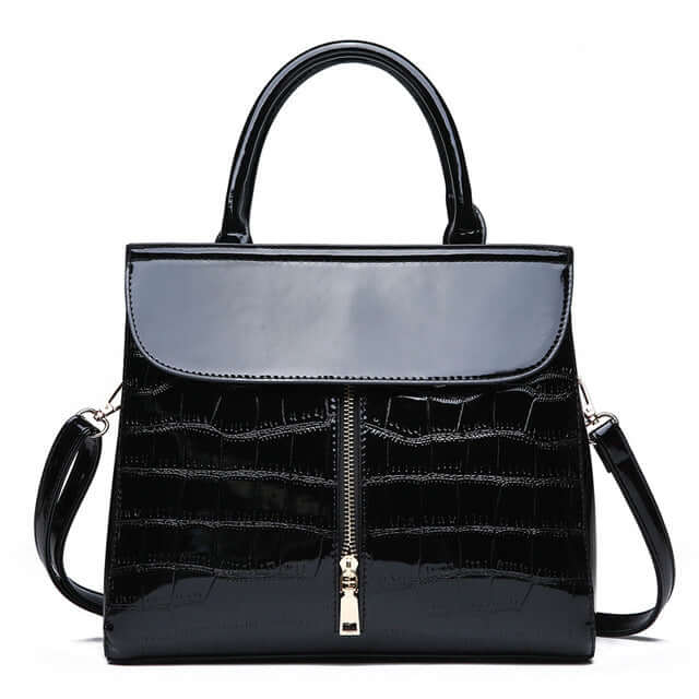 Fashionable shoulder crossbody tote bag for women in sleek black glossy finish with zipper opening.