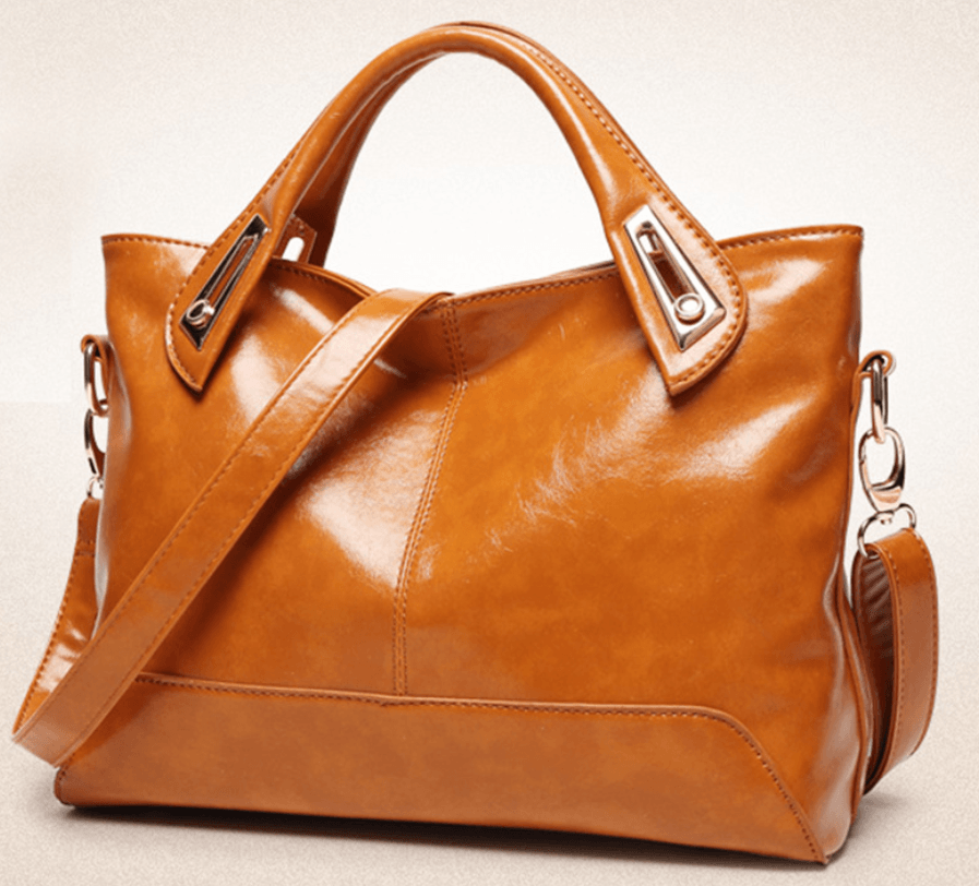 Chic crossbody bag in tan, with sleek design and dual handles, perfect for stylish outings and everyday use.