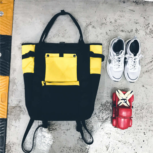Trendy Canvas Backpack in black and yellow color combination with sneakers and red roller skates on the side.