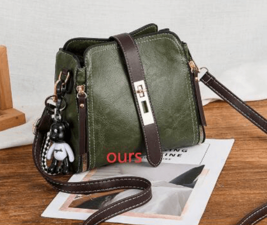 Chic doctor shoulder bag in green with stylish design and crossbody strap, featuring a trendy keychain accessory.