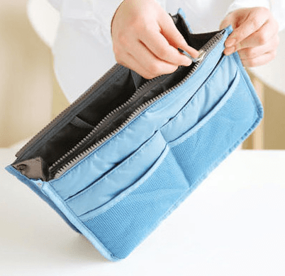 Close-up of a person holding a blue Storage Bag, Inner Bag, Makeup Bag, Organizer Bag with multiple pockets.