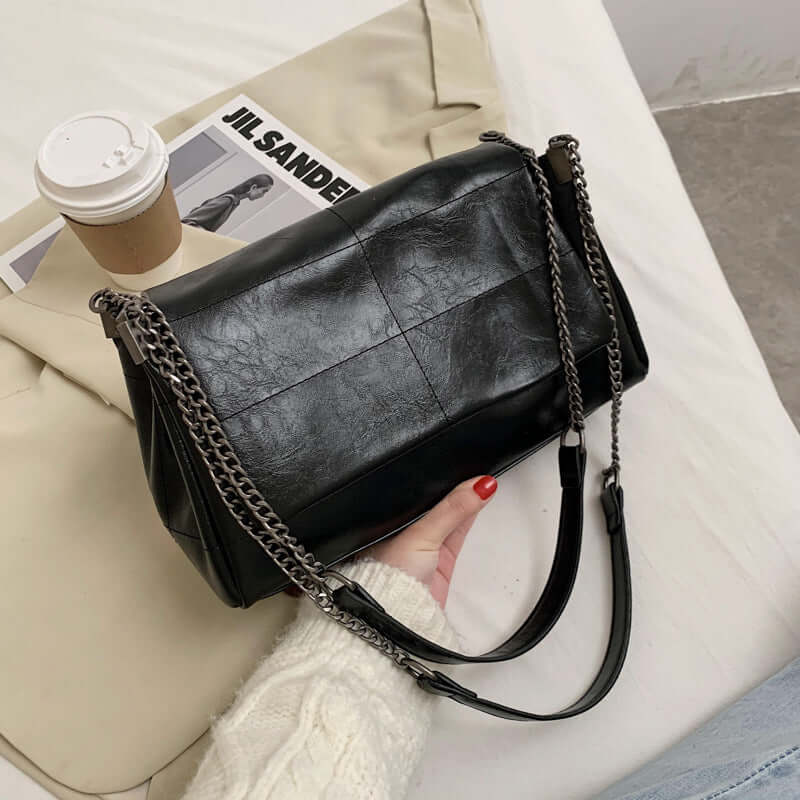 Trendy PU leather small square bag in black color, stylish chain strap, perfect for Autumn 2020 fashion.