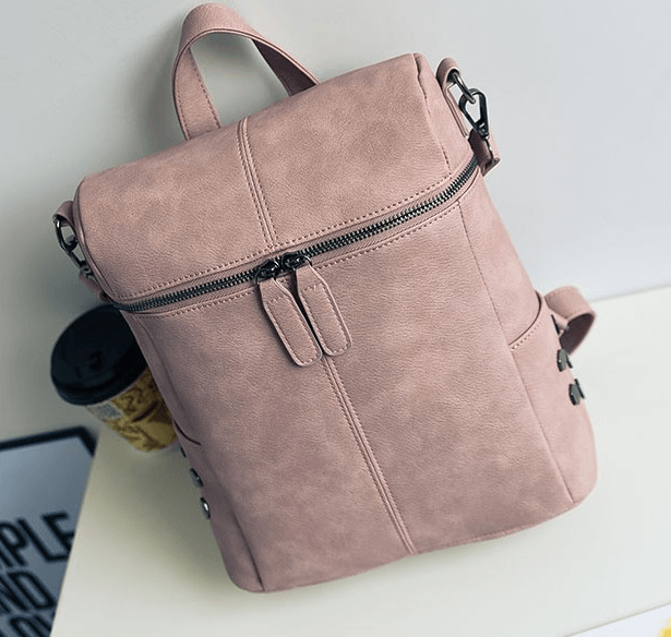 Stylish Women's Backpack in pink, ideal for students and adventurers, featuring a chic design and practical zippers.