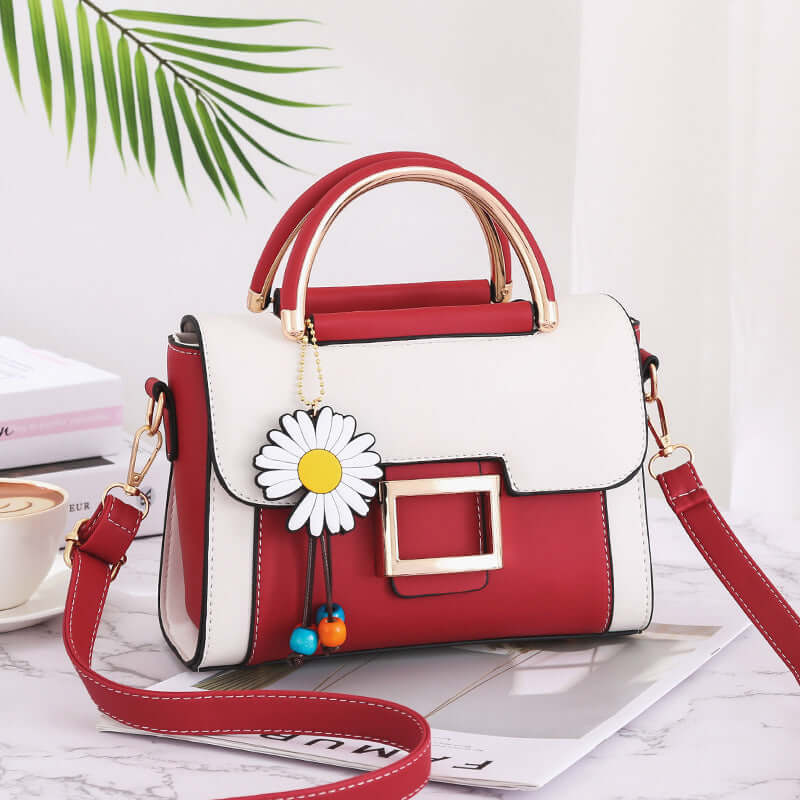 Stylish women's crossbody bag featuring a trendy red and white design with a floral charm.