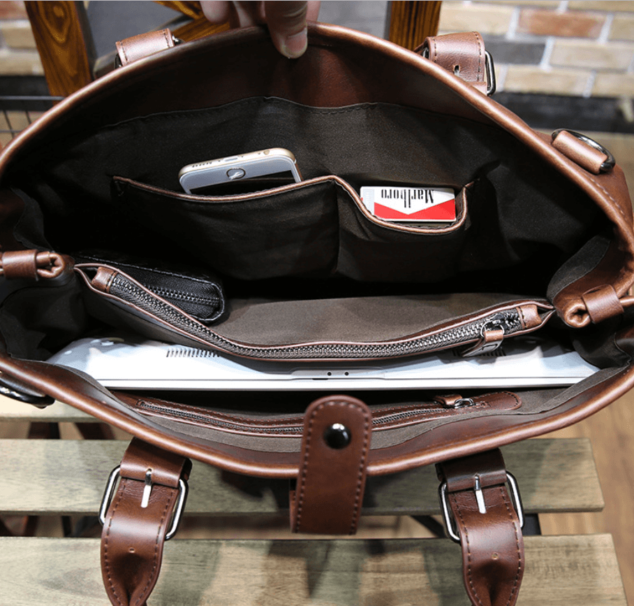 Interior view of a vintage men's casual crossbody bag showing compartments for phone and laptop.