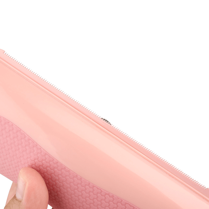 Close-up of a pink Pet Grooming Comb showcasing the ergonomic handle and serrated teeth design.