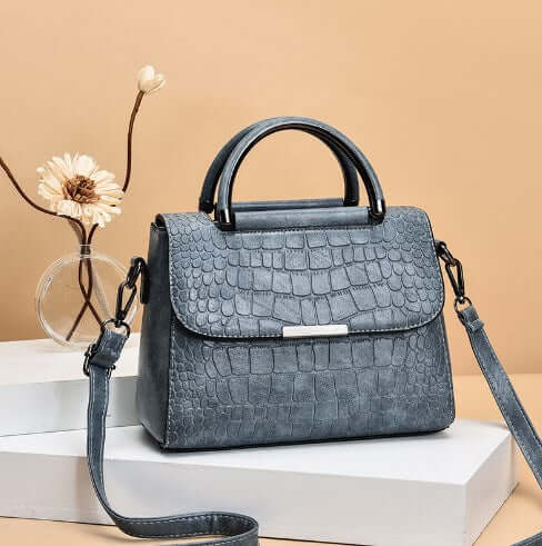 Fashionable shoulder crossbody tote bag for women in grey croc leather finish.