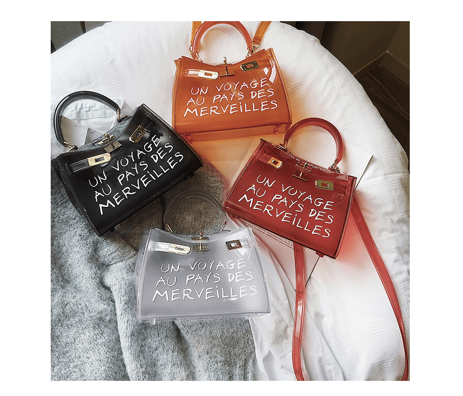 Colorful jelly shoulder bags in transparent design featuring playful text, showcasing styles in black, orange, and white.