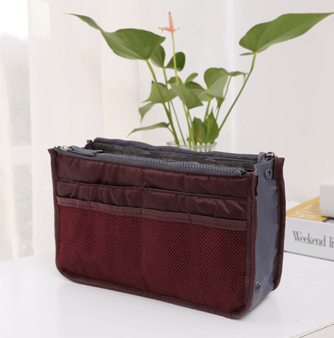 Storage Bag, Inner Bag, Makeup Bag, Organizer Bag on a table with plants in the background.