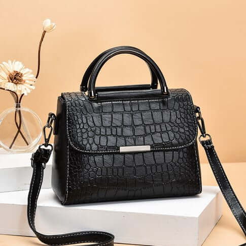 Fashionable shoulder crossbody tote bag for women with a sleek crocodile pattern in black.