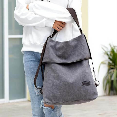Versatile canvas women's bag showcased by model, demonstrating stylish crossbody and backpack options.