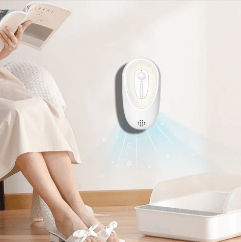 Pet Odor Eliminator for Litter Boxes mounted on wall, efficiently keeping pet space fresh and odor-free.