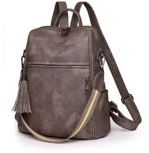 Fashionable anti-theft travel backpack with elegant design and stylish tassel, perfect for modern women.