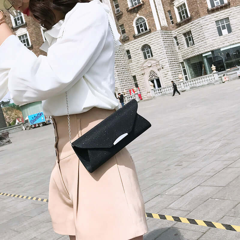 Evening Bag, Clutch, Party Bag, Crossbody Bag worn by a stylish woman in a city square.