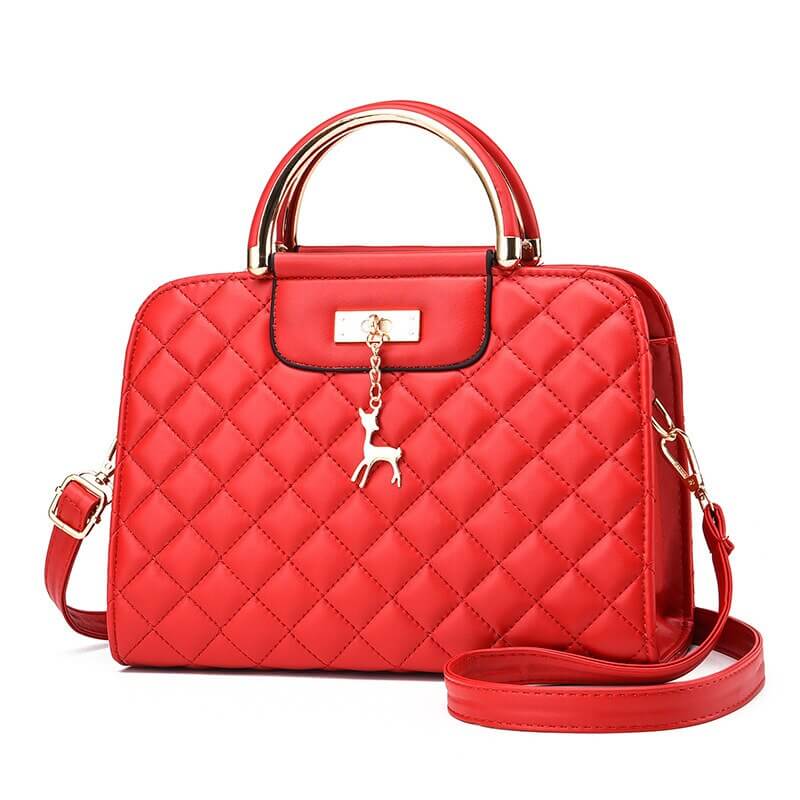 Fashionable red quilted leather shoulder bag with elegant handle and detachable strap.