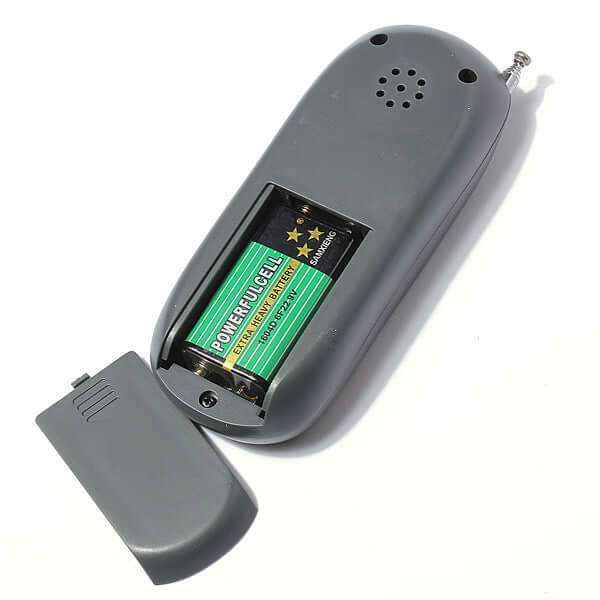 4-in-1 Remote Dog Training Device with Shock and Sound battery compartment open showing battery inside