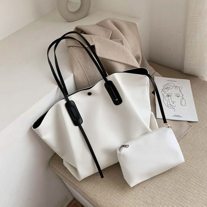 Stylish women's one shoulder handbag in white with black accents and a matching pouch, perfect for modern fashionistas.