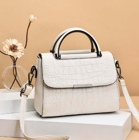 Fashionable Shoulder Crossbody Tote Bag for Women on display against a soft background with decorative elements.
