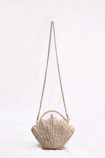 Woven straw beach bag featuring a unique dumpling bun shape and stylish chain strap.