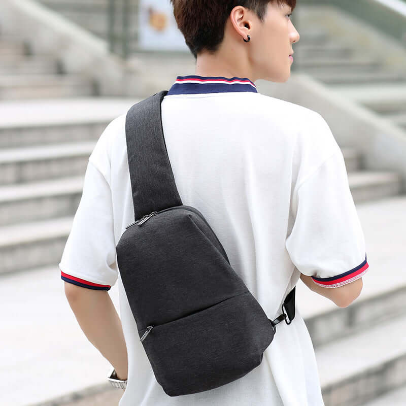 Stylish chest bags collection worn as a crossbody bag by a young man in a casual setting.
